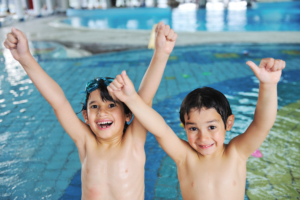 Kid having happy time in the pool water